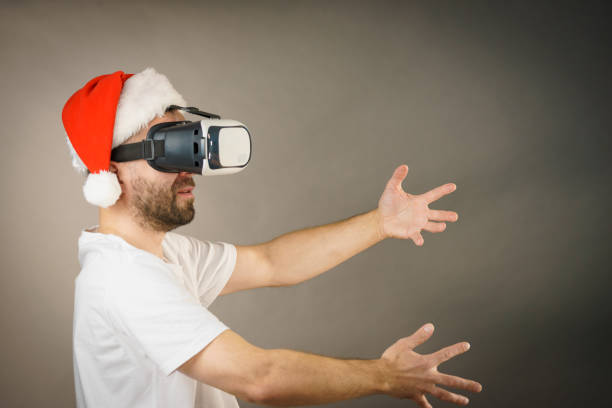 istock Man in virtual reality goggles and santa hat 1084542214