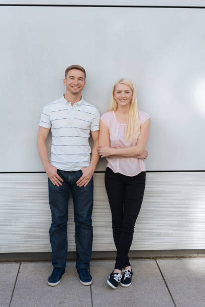 istock Friendly couple posing together against a wall 1084543158