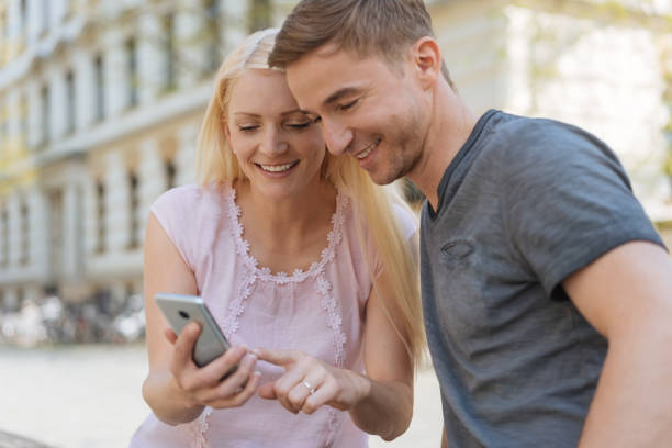 istock Happy young couple checking something on a mobile 1084543206