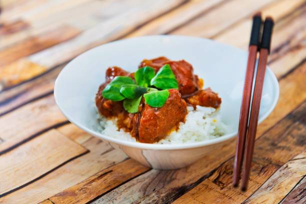istock Asian style caramel pork with rice and vegetable 1084543232