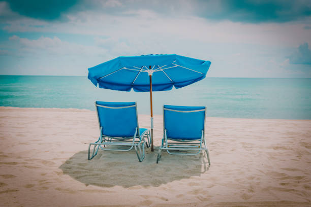 istock Two beach chairs on tropical vacation at sea 1084543260
