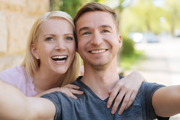 istock Laughing young couple posing for a selfie 1084543300