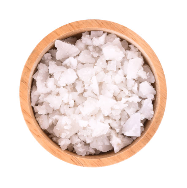 istock Sea salt in bowl on white background 1084544780