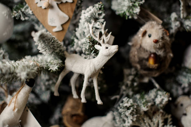 istock Beautiful Christmas fir tree toy in shape white deer and mouse 1084544816