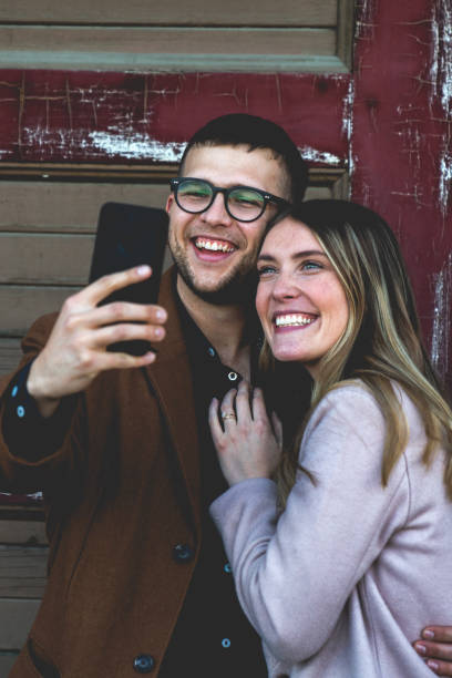 istock Twenty Something Hipster Couple Taking a Smart Phone Selfie 1084545634