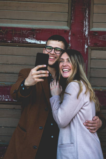 istock Twenty Something Hipster Couple Taking a Smart Phone Selfie 1084545640