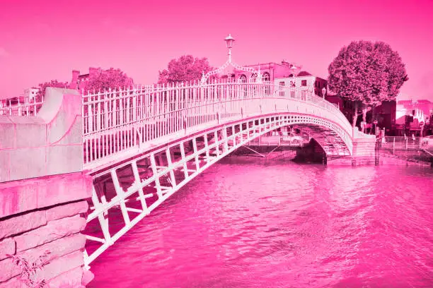 Photo of The white and elegant cast-iron Half Penny Bridge in Dublin (Ireland) - Toned image