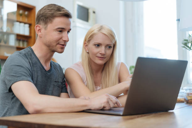istock Couple browsing the internet together on a laptop 1084549124