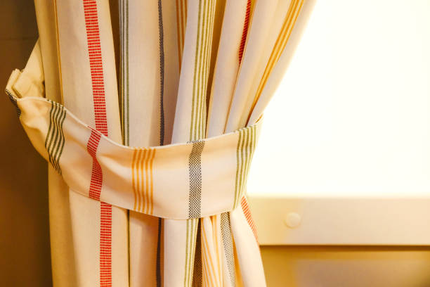 istock The curtain hangs on a horizontal bar. Against the white wall. 1084551880