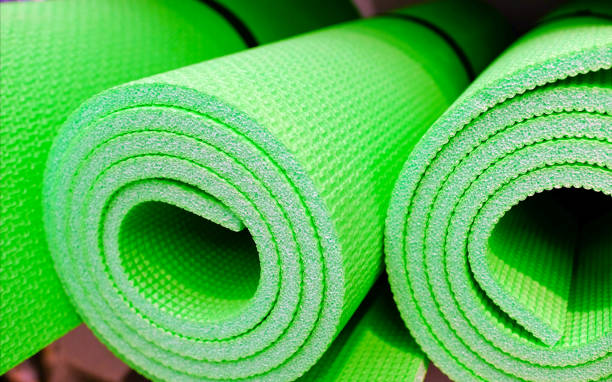 istock yoga mats on wood table with sunlight 1084551914