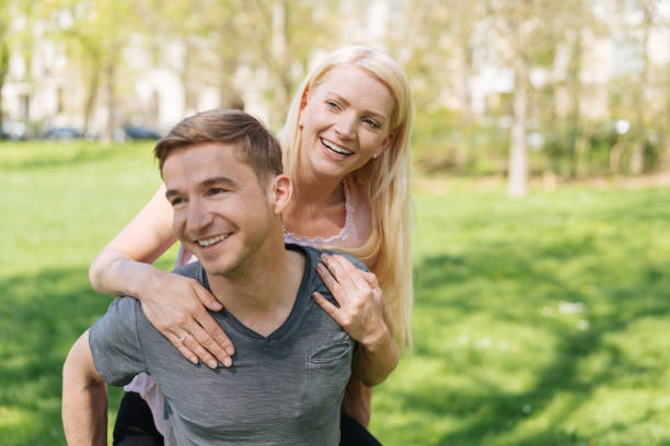 istock Joyful loving young couple enjoying a piggy back 1084552596