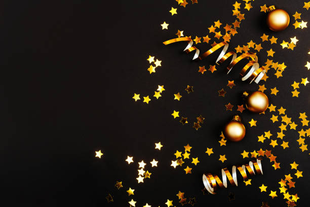 istock Beautiful christmas golden silver deco baubles on dark black background. 1084552680