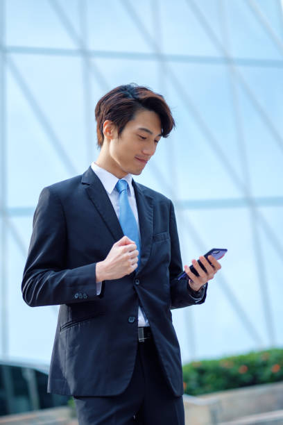 istock Young businessman using his smartphone on the street 1084554906