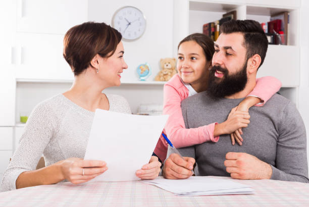 istock Parents signing property papers 1084557630