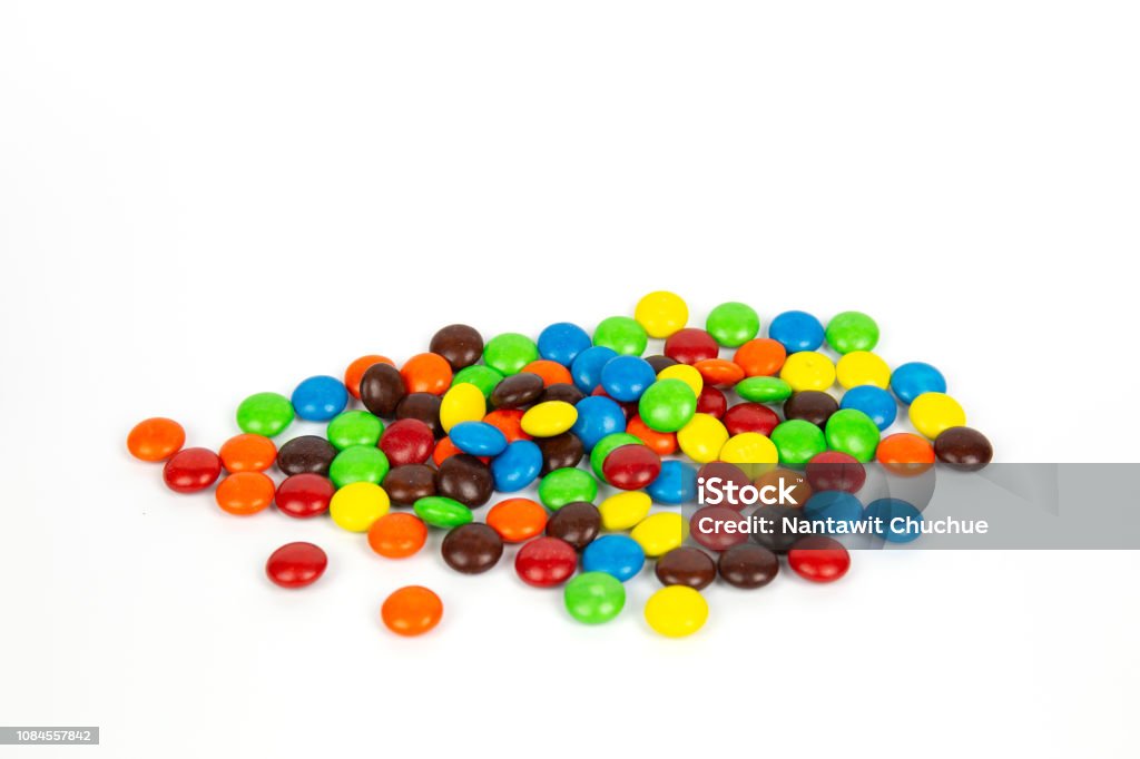 Colorful chocolate M&Ms in and out of focus on white background. Candy Stock Photo