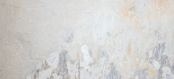 istock Old grungy wall with damaged plaster background texture. 1084558100