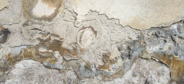 istock Old Wall With Peel Grey Stucco Texture. Retro Vintage Worn Wall Background. Decayed Cracked Rough Abstract Banner Surface. 1084559228