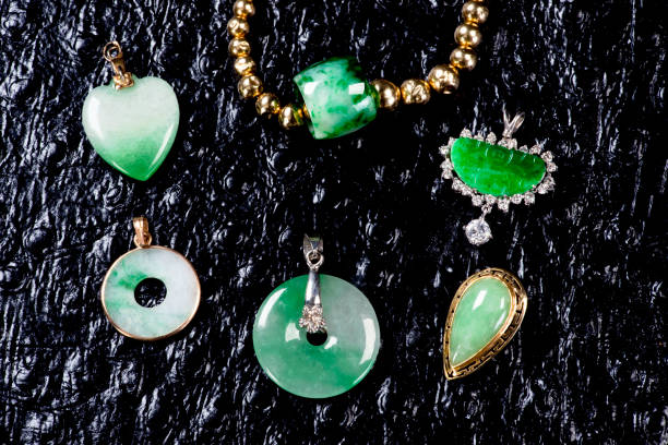 A typical Maori or Kiwi Greenstone Pendant (known as Pounamu by Kiwis and Maori alike); with a very defocused Fern & Harakeke Background.