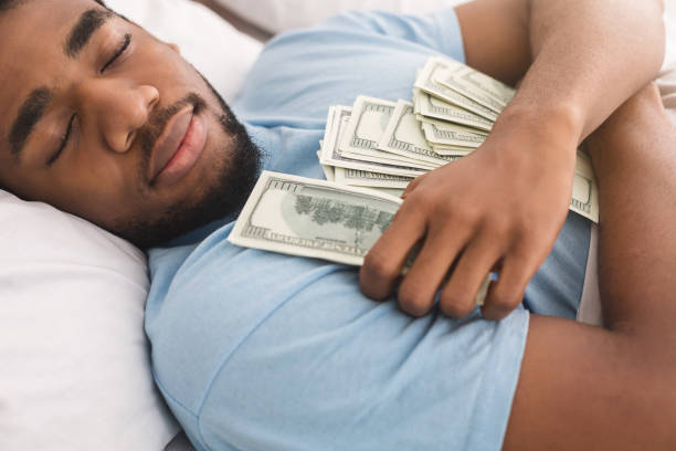 istock Man sleeping with lots of currency notes 1084565888