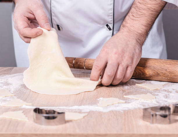 istock male cook preparing Christmas cookies 1084568278