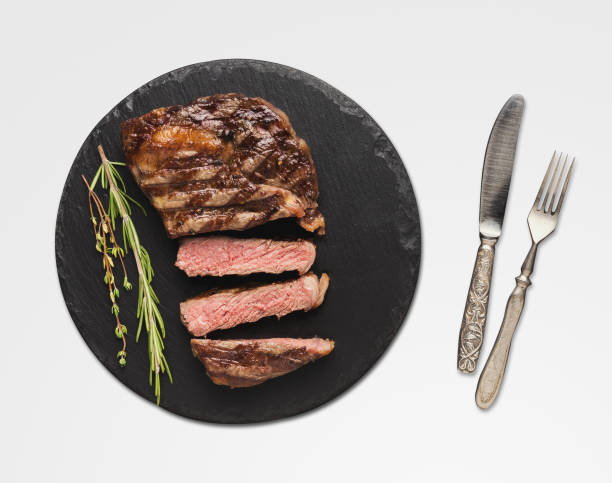 istock Rib eye steak and spices on white isolated background 1084571990