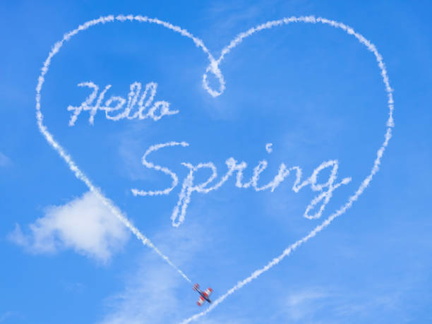 Sign of spring. Hello springtime Sign of spring. Hello springtime, word written by a acrobatic plane. Montage words in the sky stock pictures, royalty-free photos & images