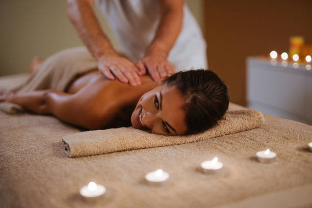 istock Young woman getting back massage from a massage therapist 1084573384