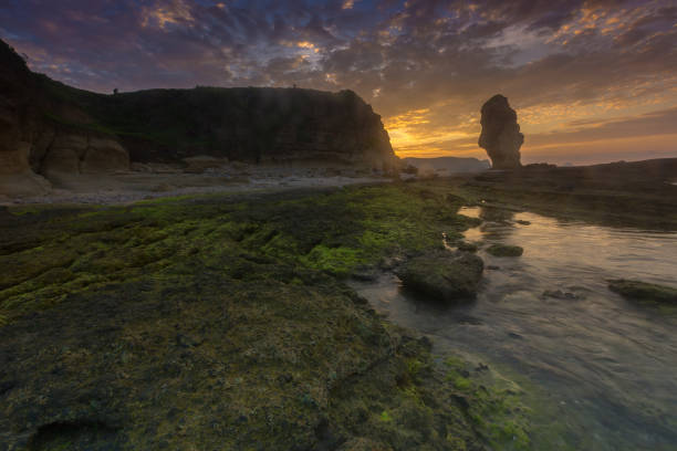 istock Rock Formation On Sea Shore Against Sky During Sunset 1084573980