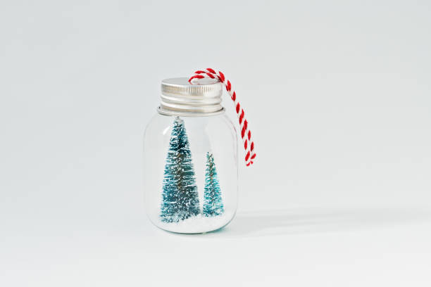 istock Miniature glass jar with artificial Christmas trees and snow 1084575336