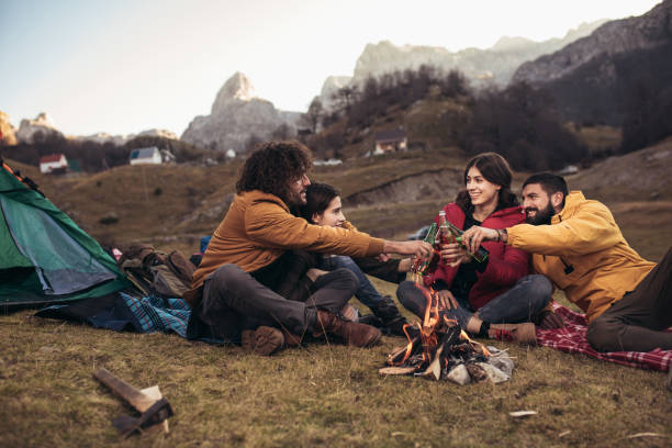 istock Group of young people around camp fire. 1084576514