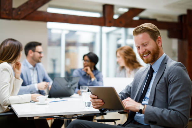 istock Young businessman using digital tablet and analyzing business report 1084576806