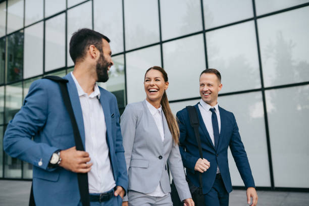 istock Three business colleagues having discussion while walking outdoors 1084579736