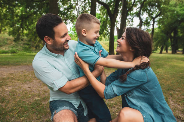 istock Happy family playing in the park 1084582476