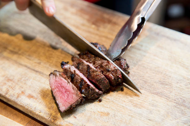istock Chopping the beefsteak on Wooden Cutting Board 1084583730