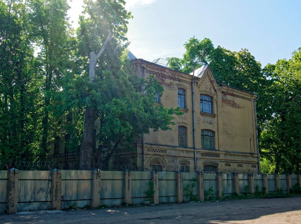 istock old house behind the fence in spring 1084596460