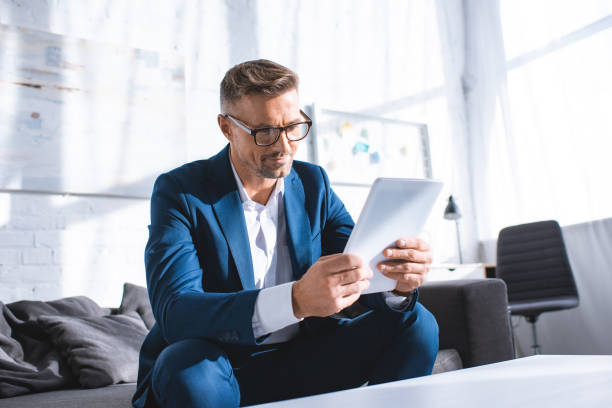 istock handsome businessman having video call on digital tablet 1084600356
