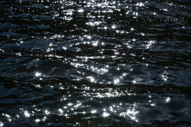 istock Surface of the water, waves with sun highlights, bright reflections. 1084601788