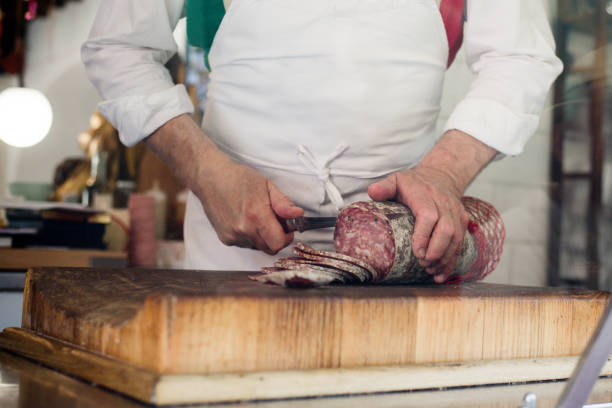 Sliced salami by butcher stock photo