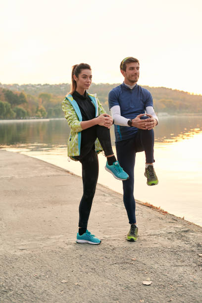 istock Young man and woman stretching before running 1084604392