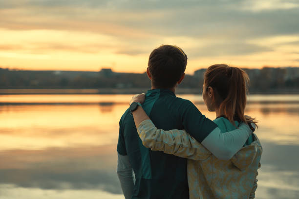 istock Happy romantic fit young couple enjoying sunset 1084604452