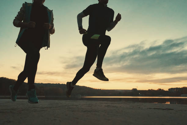 istock Sportive people legs running at sunrise 1084604462