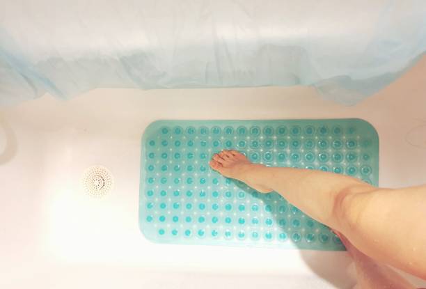 Safety precaution  in bath Conceptual image of taking safety precaution using an anti-slip in bathtub to prevent falls and accidents. mat stock pictures, royalty-free photos & images