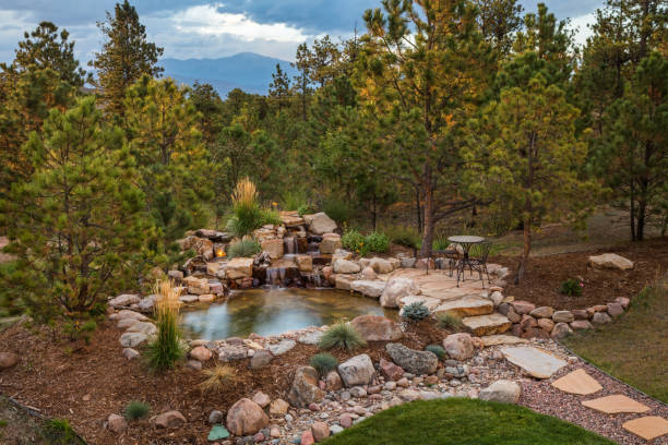 Amazing Backyard Cascading Water Feature Cascading water feature into a pond pond fountains stock pictures, royalty-free photos & images