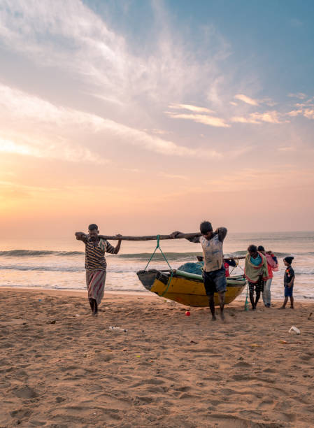 Fishermen November 16,2018. Puri, Odisha, india. Fishermen toeing their fishing boat to Puri beach. bay of bengal stock pictures, royalty-free photos & images