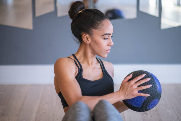 istock Woman using medicine ball 1084616276