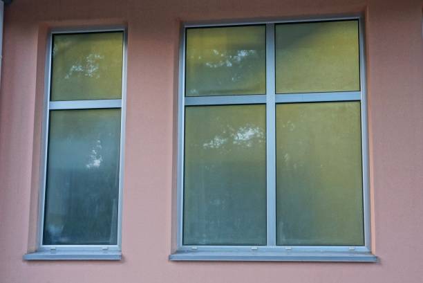 istock two new closed windows on a brown concrete wall 1084616650