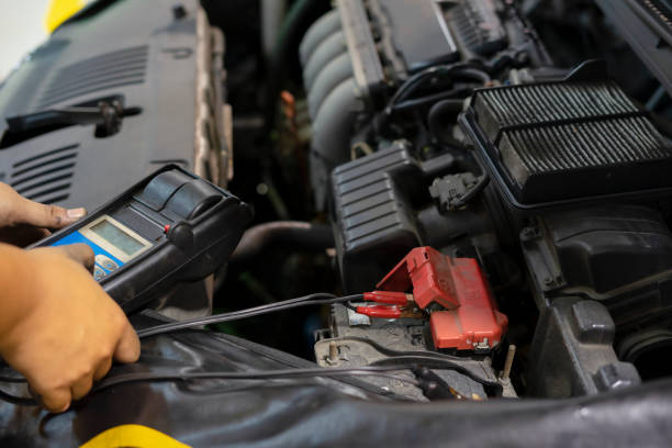 istock mechanic use voltmeter checking voltage of car battery in car service centre 1084622324