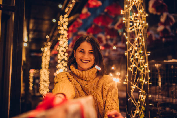 istock Girl holding Christmas present 1084622910
