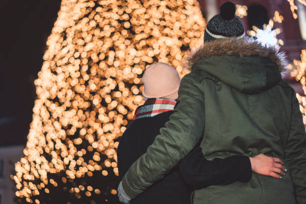 istock Couple amazed by the beautifful shiny christmas tree 1084635624