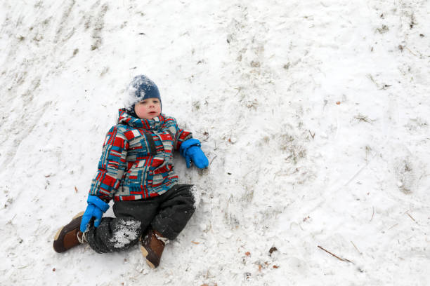 istock Tired child resting on snow 1084635644